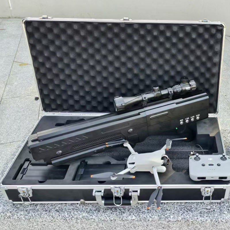 An ​​anti-drone gun​​ and a white drone with its remote controller stored in a protective hard case.